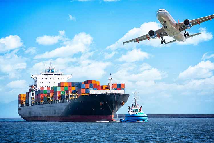 Cargo plane Flying over a cargo ship. Blue sea below and blue sky above with white clouds.
