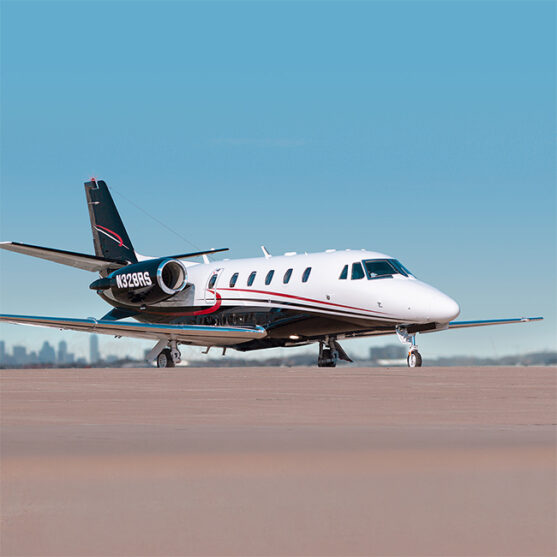 Citation XLS+ Private Jet. Based out of Dallas, Texas. White base paint with black underbelly and red stripes. For Sale by Leviate Air Group.