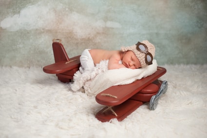 baby sleeping on toy aircraft